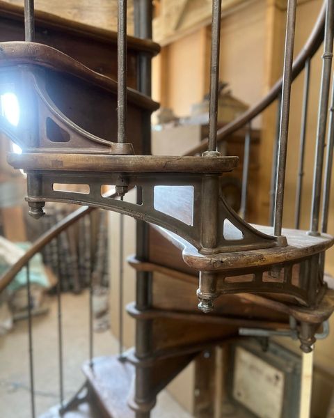 Detail of the side elements of a spiral staircase, made of cast iron and wood, model Grenoble de Luxe